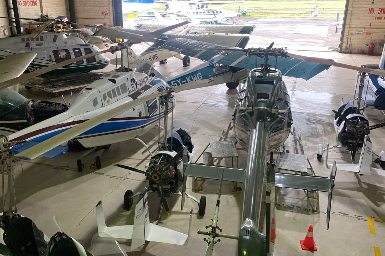 Aircraft and helicopters in a maintenance hangar
